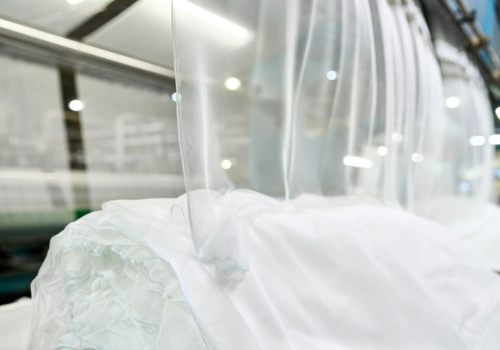 Textile netting in production, representing YAHE LN's journey from material science innovation to solutions that protect lives and livelihoods